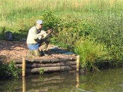 Andy Parkering playing a carp on the
                            fly